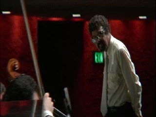 David N. Baker on stage, with a cello in the foreground